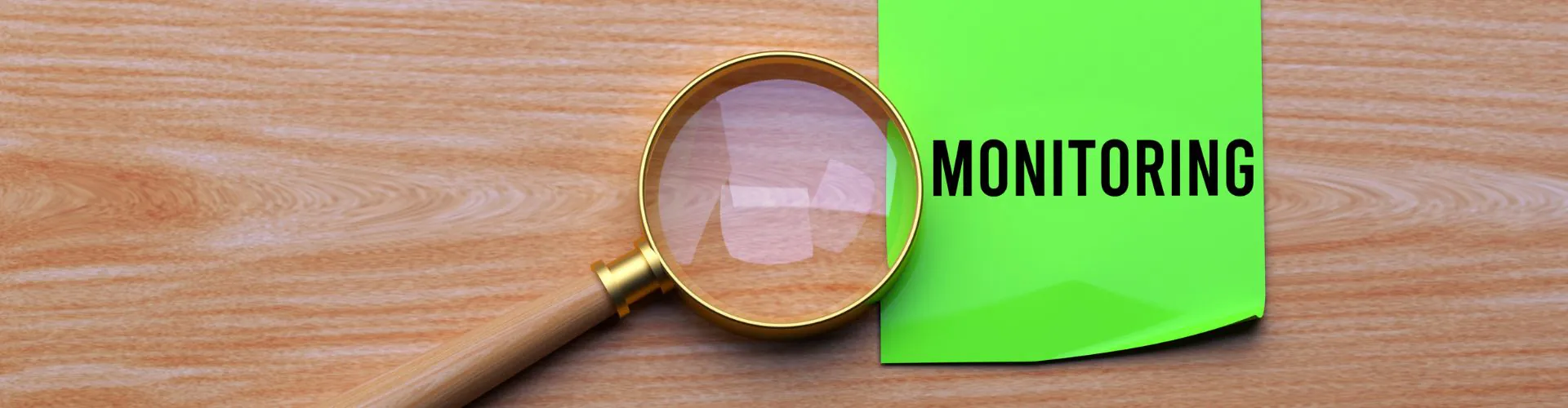 zdjęcie z lupą i kartką z napisem monitoring